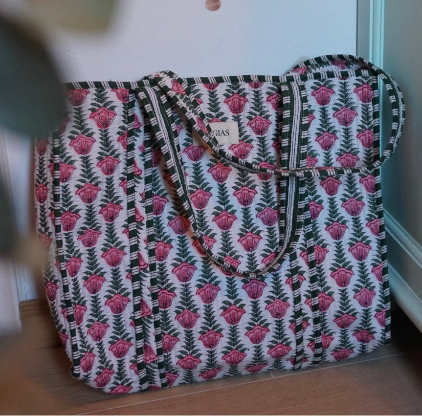 Floral patterned bag on a wooden floor.